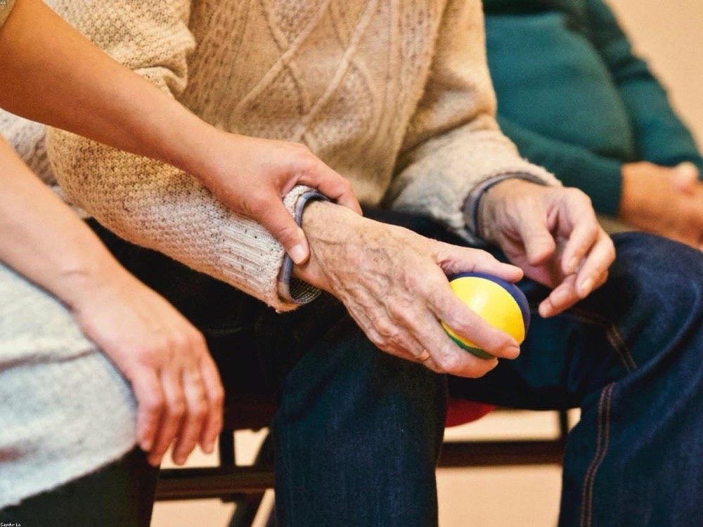 A Knight offering a caring hand to a parishioner